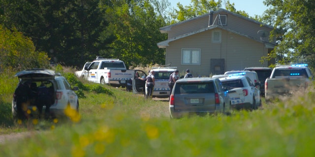 In this image taken from video, Canadian law enforcement personnel surrounded a residence on the James Smith Cree First Nation reservation in Saskatchewan, Canada, on Tuesday, Sept. 6, 2022.