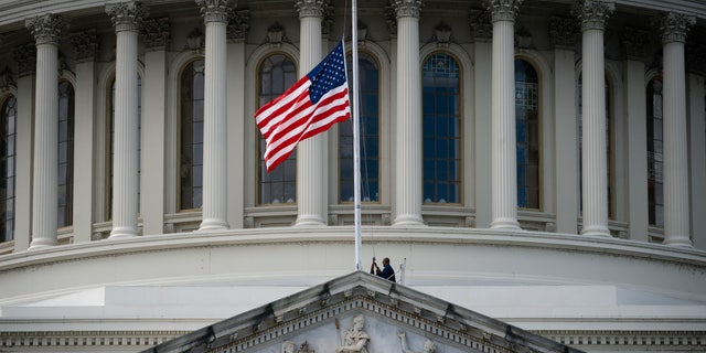 The U.S. flag is lowered to half-staff at the U.S. Capitol, on Sept. 8, 2022, on Capitol Hill in Washington, after Queen Elizabeth II died Thursday following 70 years on the throne. Gov. Eric Holcomb directed flags in the state to be flown at half-staff in Indiana.