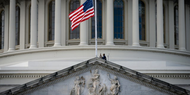 The U.S. flag is lowered to half-staff at the U.S. Capitol, on Sept. 8, 2022, on Capitol Hill in Washington, after Queen Elizabeth II died Thursday following 70 years on the throne. Gov. Eric Holcomb directed flags in the state to be flown at half-staff in Indiana.