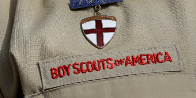 A close up of a Boy Scout uniform is photographed on Feb. 4, 2013, in Irving, Texas. A Delaware bankruptcy judge has approved a $2.46 billion reorganization plan proposed by the Boy Scouts of America that would allow it to continue operating while compensating tens of thousands of men who say they were sexually abused as Boy Scouts.