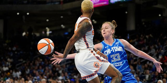 Connecticut Sun's Courtney Williams passes behind her back as Chicago Sky's Emma Meesseman defends during the first half of Game 5 in a WNBA basketball playoffs semifinal Thursday, Sept. 8, 2022, in Chicago. 