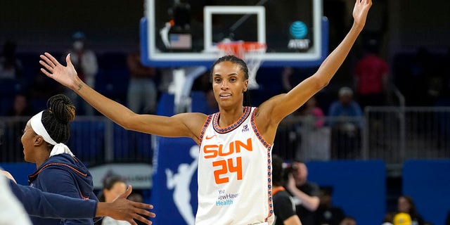 Connecticut Sun's DeWanna Bonner begins to celebrate the team's 72-63 win over the Chicago Sky in Game 5 of a WNBA basketball playoffs semifinal Thursday, Sept. 8, 2022, in Chicago. 