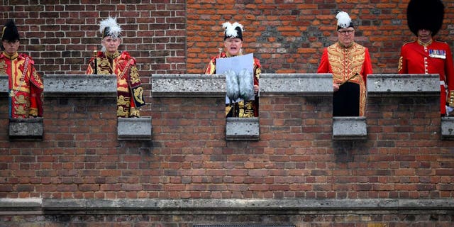 On Saturday 10 September 2022, from the balcony of the Friary Court at St. James's Palace in London, the Garter Principal King of Arms, David Vines White, reads out the proclamation of the new King, center, Charles III.