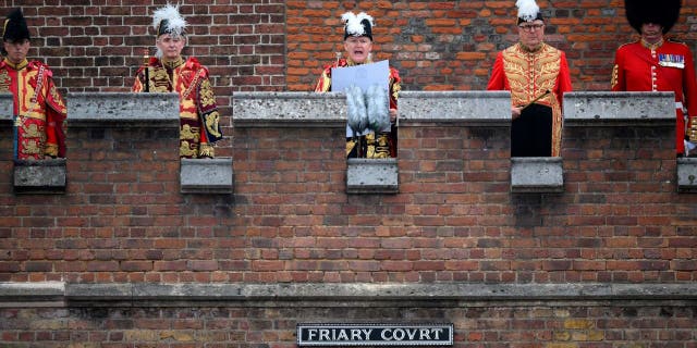 On Saturday 10 September 2022, from the balcony of the Friary Court at St. James's Palace in London, the Garter Principal King of Arms, David Vines White, reads out the proclamation of the new King, center, Charles III.