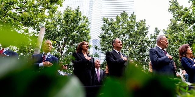 New York City mayor Eric Adams, former New York City mayor Michael Bloomberg, Vice President Kamala Harris and her husband Doug Emhoff, Senate Majority Leader Chuck Schumer and New York Governor Kathy Hochul stand for the national anthem at the ceremony to commemorate the 21st anniversary of the Sept. 11 terrorist attacks in New York. 