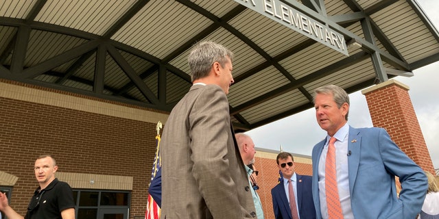 Georgia Gov. Brian Kemp speaks to an Oconee County school administrator after announcing K-12 priorities for his second term at a reelection campaign event at Dove Creek Elementary School in Statham, Georgia. 
