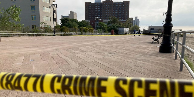 Crime scene tape stretches across a section of the Coney Island boardwalk near a beach where three children were found dead in the surf, Monday, Sept. 12, 2022.