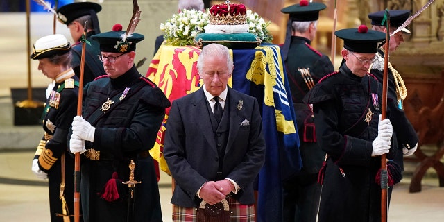 Britain's King Charles III, center and other members of the Royal Family hold a vigil at the coffin of Queen Elizabeth II at St Giles' Cathedral in Edinburgh, Scotland, Monday, September 12, 2022.