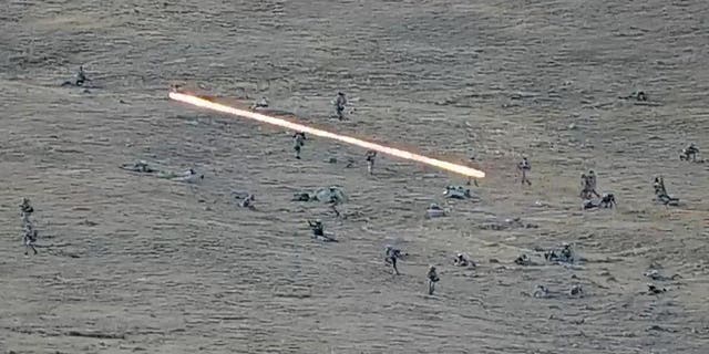 In this image taken from a YouTube footage released by Armenian Defense Ministry on Tuesday, Sept. 13, 2022, shows Azerbaijanian servicemen crossing the Armenian-Azerbaijani border and approaching the Armenian positions. Armenia's prime minister says that 49 soldiers have been killed in nighttime attacks by Azerbaijan. (Armenian Defense Ministry via AP)