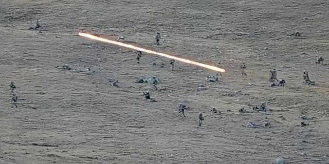 In this image taken from a YouTube footage released by Armenian Defense Ministry on Tuesday, Sept. 13, 2022, shows Azerbaijanian servicemen crossing the Armenian-Azerbaijani border and approaching the Armenian positions. Armenia's prime minister says that 49 soldiers have been killed in nighttime attacks by Azerbaijan. (Armenian Defense Ministry via AP)