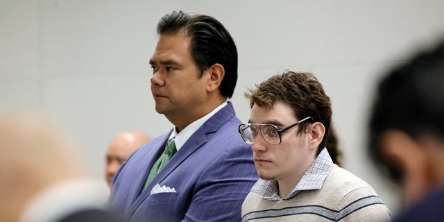 Marjory Stoneman Douglas High School shooter Nikolas Cruz stands with Chief Assistant Public Defender David Wheeler as jurors enter the courtroom of Cruz's trial at the Broward County Courthouse in Fort Lauderdale, Fla., Tuesday, Sept. 13, 2022. Cruz previously plead guilty to all 17 counts of premeditated murder and 17 counts of attempted murder in the 2018 shootings. (Amy Beth Bennett/South Florida Sun Sentinel via AP, Pool)