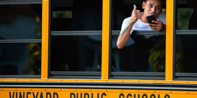 A man who was among a group of immigrants to arrive on Martha's Vineyard flashed a thumbs-up on Wednesday, Sept. 14, 2022, in Edgartown, Mass. 