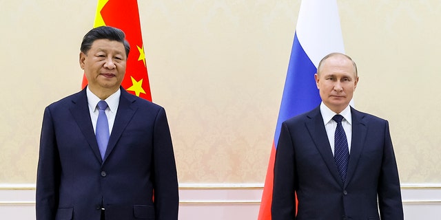 Chinese President Xi Jinping, left, and Russian President Vladimir Putin pose for a photo on the sidelines of the Shanghai Cooperation Organization summit in Samarkand, Uzbekistan, Thursday, Sept. 15, 2022. 