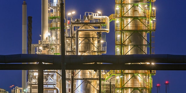 The oil refinery on the industrial site of PCK-Raffinerie GmbH, jointly owned by Rosneft, are illuminated in the evening in Schwedt, Germany, on May 4, 2022. 