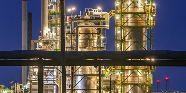 The oil refinery on the industrial site of PCK-Raffinerie GmbH, jointly owned by Rosneft, are illuminated in the evening in Schwedt, Germany, on May 4, 2022. 
