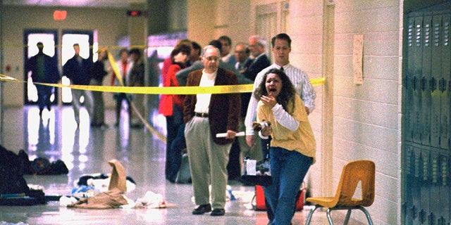 A Heath High School student screams at seeing the scene of a shooting where fellow student Michael Carneal opened fire, leaving three students dead and five wounded on Dec. 1, 1997, near Paducah, Ky.