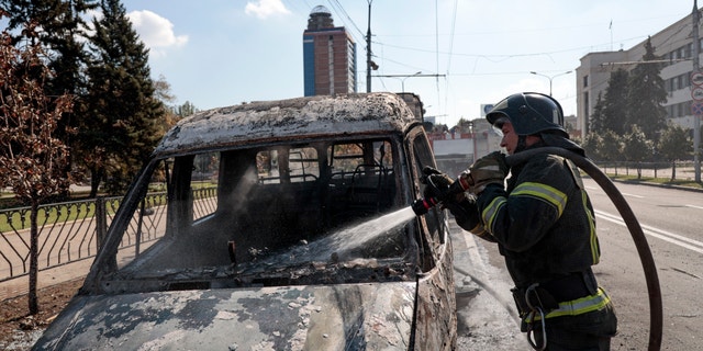 A firefighter extinguishes a burning vehicle after shelling in Donetsk, area controlled by Russian-backed separatist forces, eastern Ukraine, Saturday, Sept. 17, 2022. A Ukrainian shelling attack killed four people in downtown Donetsk on Saturday. According to the city's Mayor Alexey Kulemzin, fragments of munitions for Caesar howitzers were found. 