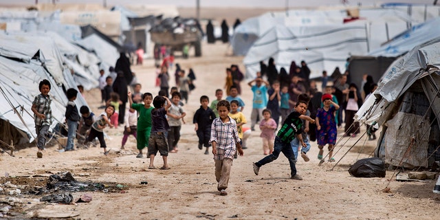 Children gather outside their tents, at al-Hol camp, in Hasakeh province, Syria, May 1, 2021.