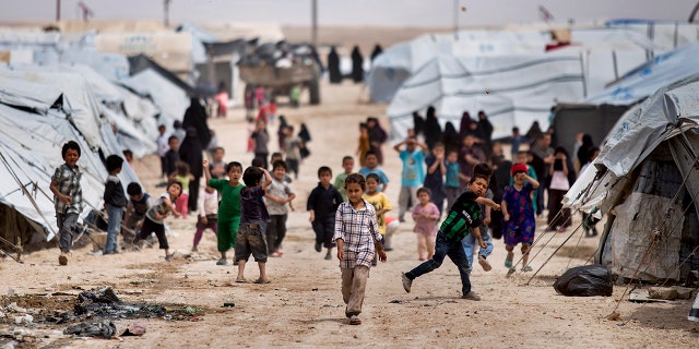 Children gather outside their tents, at al-Hol camp, in Hasakeh province, Syria, May 1, 2021.