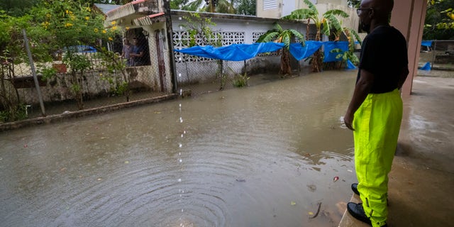 A worker of the Loiza municipality calls on residents to evacuate due to imminent flooding due to the rains of Hurricane Fiona, in Loiza, Puerto Rico, Sunday, September 18, 2022.