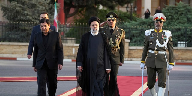 Iranian President Ebrahim Raisi, center, reviews an honor guard during his official departure ceremony as he leaves Tehran's Mehrabad airport to New York to attend annual UN General Assembly meeting, Monday, Sept. 19, 2022. (AP Photo/Vahid Salemi)