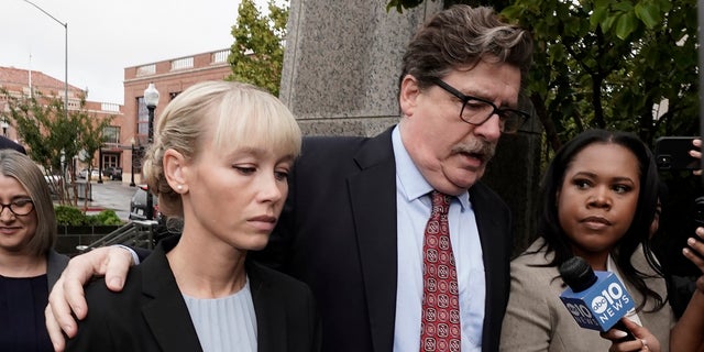 Sherri Papini arrives at the federal courthouse for sentencing accompanied by her attorney, William Portanova, right, in Sacramento, Calif., Monday, Sept. 19, 2022.