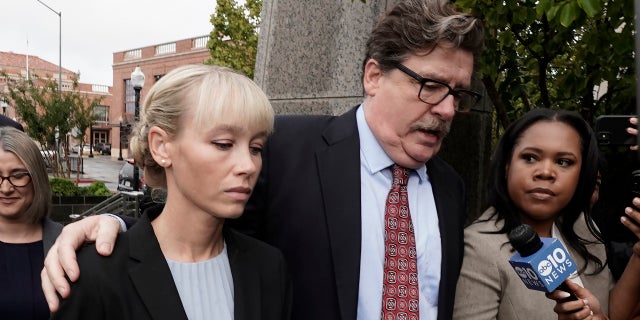 Sherri Papini arrives at the federal courthouse for sentencing accompanied by her attorney, William Portanova, right, in Sacramento, California, Monday, Sept. 19, 2022. Federal prosecutors are asking that she be sentenced to eight months in prison for faking her own kidnapping in 2016. 