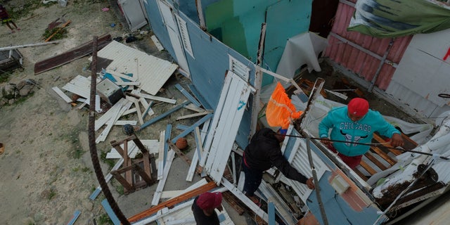 Residents replace the roof of a house torn off by Hurricane Fiona in Kosovo's low-income neighborhood in Veron de Punta Cana, Dominican Republic, Monday, September 19, 2022.