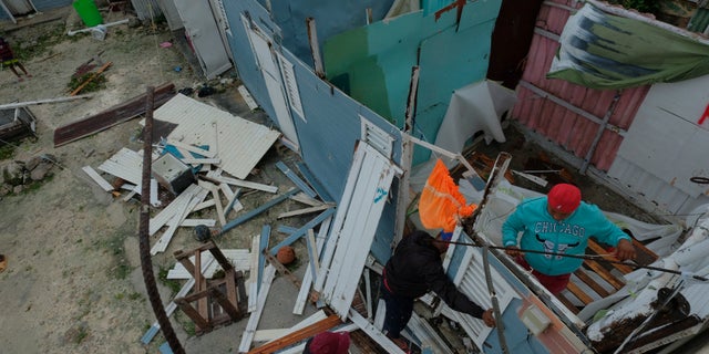 Residents replace a home's roof that was torn off by Hurricane Fiona in the low-income neighborhood of Kosovo in Veron de Punta Cana, Dominican Republic, Monday, Sept. 19, 2022.