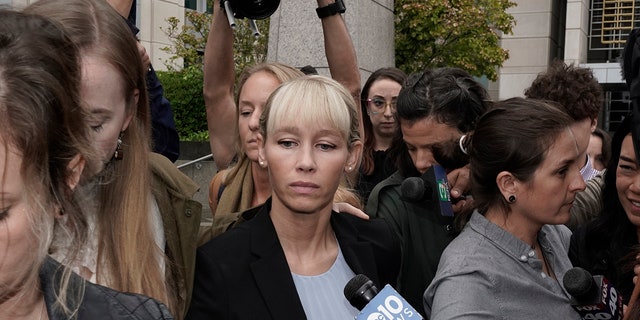 Sherri Papini, center, leaves the federal courthouse after Federal Judge William Shubb sentenced her to 18 months in federal prison, in Sacramento, California, Monday, Sept. 19, 2022. Federal prosecutors had asked that she be sentenced to eight months in prison for faking her own kidnapping in 2016.