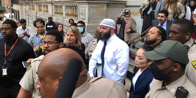 Adnan Syed, center, leaves the Elijah E. Cummings Courthouse, Monday, Sept. 19, 2022, in Baltimore. A judge has ordered the release of Syed after overturning his conviction for a 1999 murder that was chronicled in the hit podcast "Serial." 