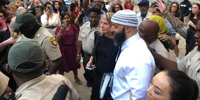 Adnan Syed, center, leaves the Cummings Courthouse, Monday, Sept. 19, 2022, in Baltimore. A judge has ordered the release of Syed after overturning his conviction for a 1999 murder that was chronicled in the hit podcast "Serial."