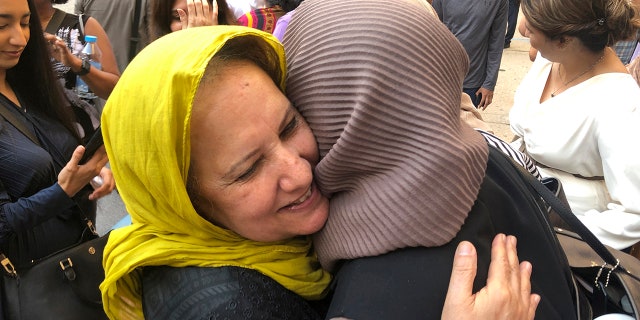 Shamim Syed, Adnan Syed's mother, left, celebrates with others outside the Cummings Courthouse, Monday, Sept. 19, 2022, in Baltimore. A judge has ordered the release of Adnan Syed after overturning his conviction for a 1999 murder that was chronicled in the hit podcast "Serial."