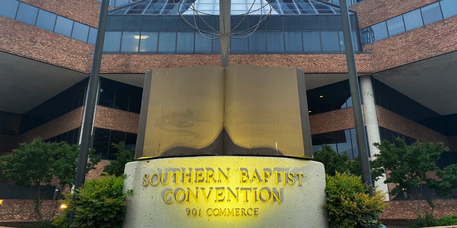 A cross and Bible sculpture stand outside the Southern Baptist Convention