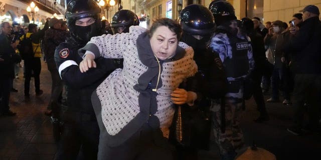 Riot police detain a woman during a protest against troop mobilization in Moscow on Sept. 21, 2022. Russian President Vladimir Putin recently ordered a partial mobilization of reservists in Russia.