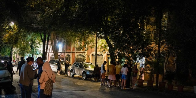 People gather outside after an earthquake was felt in Mexico City, Thursday, Sept. 22, 2022. The earthquake struck early Thursday, just three days after a deadly earthquake shook western and central Mexico.