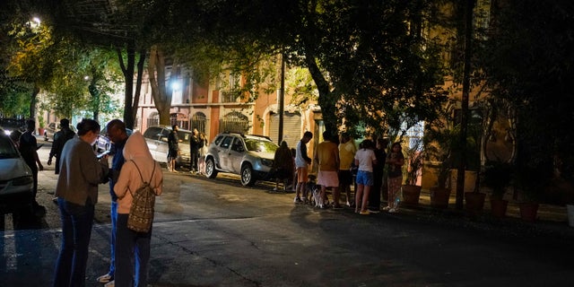 People gather outside after an earthquake was felt in Mexico City, Thursday, Sept. 22, 2022. The earthquake struck early Thursday, just three days after a deadly earthquake shook western and central Mexico.