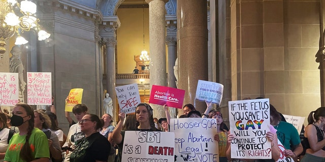 Abortion-rights protesters fill Indiana Statehouse corridors and cheer outside legislative chambers, Friday, Aug. 5, 2022, as lawmakers vote to concur on a near-total abortion ban, in Indianapolis. 