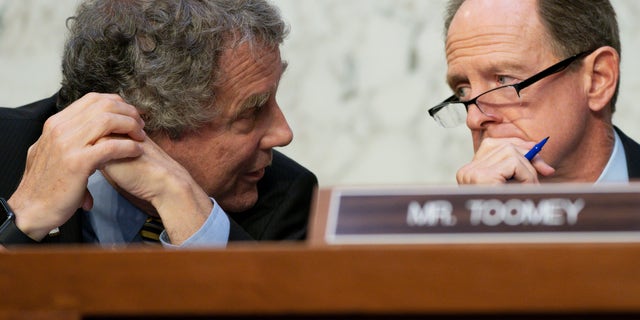 Senate Banking Committee Chairman Sen. Sherrod Brown, D-Ohio, left, speaks with ranking member Sen. Pat Toomey, R-Pa., during an annual Wall Street oversight hearing, Thursday, Sept. 22, 2022. 