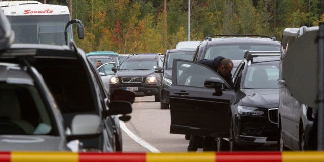 Cars queue to cross the border from Russia to Finland at the Vaalimaa border check point in Virolahti in Virolahti, Finland, Friday, Sept. 23, 2022. 