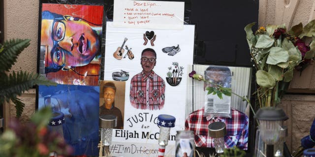 FILE - A makeshift memorial stands at a site across the street from where Elijah McClain was stopped by Aurora, Colo., Police Department officers while walking home, before family members hold a news conference, Friday, July 3, 2020, in Aurora, Colo. Three Aurora Police Department officers have left the force after photographs surfaced of them reenacting the chokehold used on McClain across the road from the memorial, which sits in the shadow of Interstate 225. (AP Photo/David Zalubowski, File)