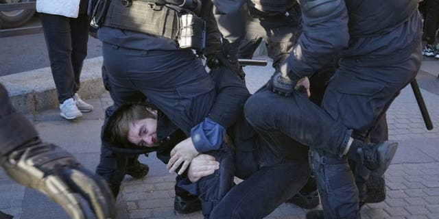 Russian policemen detain a demonstrator protesting against mobilization in St. Petersburg, Russia, on Sept. 24, 2022.