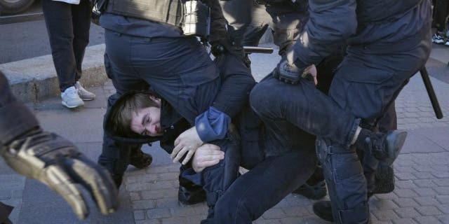 Russian policemen detain a demonstrator protesting against mobilization in St. Petersburg, Russia, on Sept. 24, 2022.