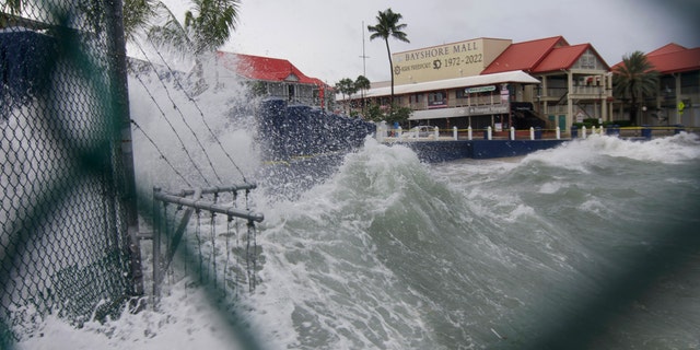 Waves crash against a seawall as Hurricane Ian passes through George Town, Grand Cayman island, Monday, Sept. 26, 2022.