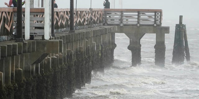 Waves crash along the Ballast Point Pier ahead of Hurricane Ian, on Wednesday, Sept. 28, 2022, in Tampa, Fla. 