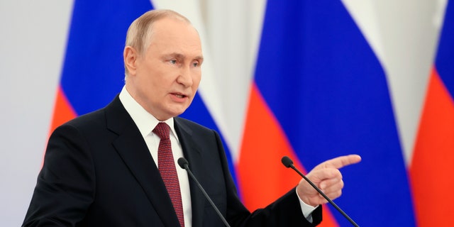 Russian President Vladimir Putin gestures during a ceremony to sign the treaties for four regions of Ukraine to join Russia, at the Kremlin in Moscow Friday, Sept. 30, 2022. 