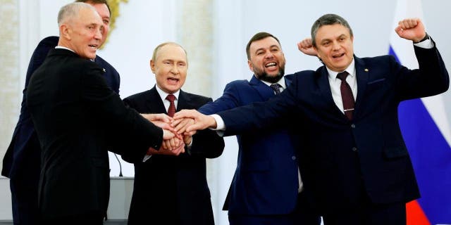 From left, Moscow-appointed head of Kherson Region Vladimir Saldo, Moscow-appointed head of Zaporizhzhia region Yevgeny Balitsky, Russian President Vladimir Putin, Denis Pushilin, leader of self-proclaimed of the Donetsk People's Republic and Leonid Pasechnik, leader of self-proclaimed Luhansk People's Republic pose for a photo during a ceremony to sign the treaties for four regions of Ukraine to join Russia, at the Kremlin in Moscow, Friday, Sept. 30, 2022. 