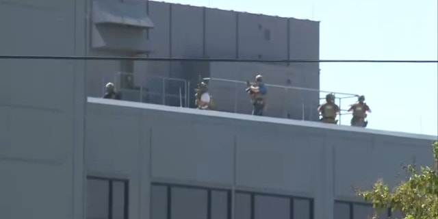 Law enforcement in tactical gear seen on the roof of the St. Vincent Hospital in Sherwood, Arkansas.