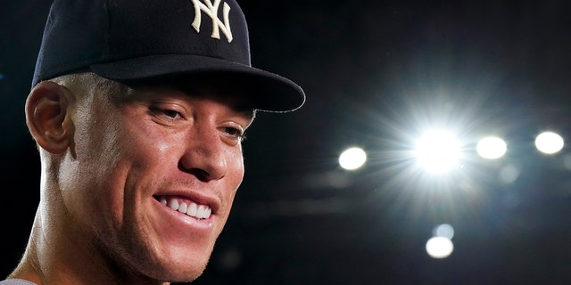 New York Yankees' Aaron Judge smiles as he speaks during an interview after the team's baseball game against the Toronto Blue Jays, in which he hit his 61st home run of the season, Wednesday, Sept. 28, 2022, in Toronto. 