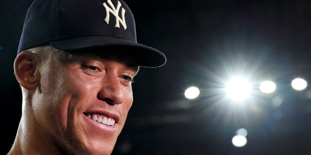 New York Yankees' Aaron Judge smiles during an interview after hitting his 61st home run of the season after the team's baseball game against the Toronto Blue Jays in Toronto, Wednesday, Sept. 28, 2022. 